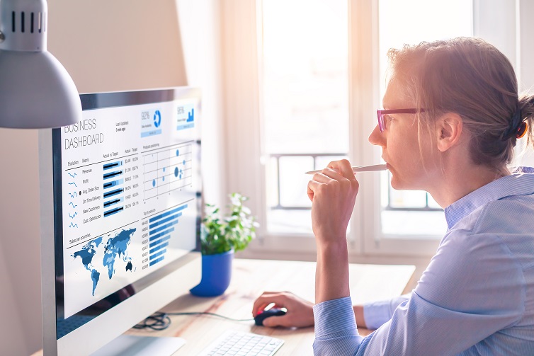 Image of businesswoman looking at a business intelligence dashboard
